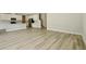 Open-concept living area with wood floors connecting the kitchen and living spaces at 12758 Oak Hill Way, Parrish, FL 34219
