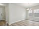 Bright, open-concept living room with wood floors, natural light and a modern chandelier at 12758 Oak Hill Way, Parrish, FL 34219