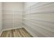 Walk-in pantry features wood-look flooring and ample white wire shelving at 12758 Oak Hill Way, Parrish, FL 34219