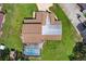 Home exterior with a screened-in pool and a large, fenced backyard at 1357 Dinsmore Ct, New Port Richey, FL 34655