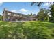 Large backyard with a screened pool enclosure and ample green space at 1357 Dinsmore Ct, New Port Richey, FL 34655