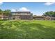 Expansive backyard featuring a screened pool area and a lush green lawn at 1357 Dinsmore Ct, New Port Richey, FL 34655