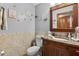 Elegant bathroom with wooden vanity, decorative tiles, and stylish fixtures at 1357 Dinsmore Ct, New Port Richey, FL 34655