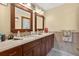 Bathroom features a double vanity with wood cabinets and a speckled countertop and tile flooring at 1357 Dinsmore Ct, New Port Richey, FL 34655