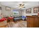 The bedroom features wood floors, a ceiling fan, and a gray sofa at 1357 Dinsmore Ct, New Port Richey, FL 34655