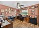 Home office featuring a comfortable desk, hardwood floor, and an array of decorations at 1357 Dinsmore Ct, New Port Richey, FL 34655