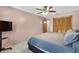 Bright bedroom features a ceiling fan, closet with sliding doors, and a mounted TV at 1357 Dinsmore Ct, New Port Richey, FL 34655