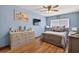 Bedroom featuring wood floors, a bed, and multiple dressers at 1357 Dinsmore Ct, New Port Richey, FL 34655