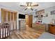 The bedroom features wood floors, a ceiling fan, closet, and multiple dressers at 1357 Dinsmore Ct, New Port Richey, FL 34655