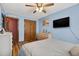 Bedroom featuring wood floors, a bed, and a television at 1357 Dinsmore Ct, New Port Richey, FL 34655