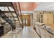 Welcoming foyer featuring tile flooring, staircase, and seamless transition to the living area at 1357 Dinsmore Ct, New Port Richey, FL 34655