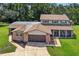 Charming two-story brick home with a well-manicured lawn and inviting screened-in porch at 1357 Dinsmore Ct, New Port Richey, FL 34655