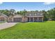 Charming two-story home features brick accents, an attached garage, and well-manicured lawn at 1357 Dinsmore Ct, New Port Richey, FL 34655