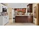 Well-equipped kitchen featuring dark cabinetry and stainless steel appliances in a cozy layout at 1357 Dinsmore Ct, New Port Richey, FL 34655