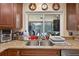 Close-up of the granite kitchen sink and counter area with a view to the lanai at 1357 Dinsmore Ct, New Port Richey, FL 34655