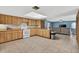 Spacious kitchen featuring wood cabinets and an adjoining living area, perfect for Gathering gatherings at 1357 Dinsmore Ct, New Port Richey, FL 34655