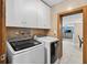 Clean laundry room featuring modern front-load washer and dryer with plenty of storage space at 1357 Dinsmore Ct, New Port Richey, FL 34655
