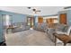 Relaxing living room boasts reclining sofas, access to the lanai, and access to the kitchen at 1357 Dinsmore Ct, New Port Richey, FL 34655