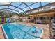 Inviting screened pool with patio seating, perfect for outdoor relaxation and entertaining at 1357 Dinsmore Ct, New Port Richey, FL 34655