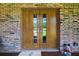 Charming double doors on front porch with painted brick and an exterior home security camera at 1357 Dinsmore Ct, New Port Richey, FL 34655