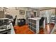 Craft room with hardwood flooring, cabinets, storage, and functional workspace and lots of lighting at 1357 Dinsmore Ct, New Port Richey, FL 34655