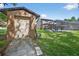 Backyard view of a storage shed with exterior garage door at 1357 Dinsmore Ct, New Port Richey, FL 34655