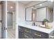 Stylish bathroom featuring a dark wood vanity, a white countertop, and adjacent doorway at 140 88Th Ne Ave, St Petersburg, FL 33702