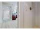 Bright bathroom featuring white subway tile, a shower with grab bar and white cabinets in the background at 140 88Th Ne Ave, St Petersburg, FL 33702