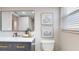 Charming bathroom featuring modern fixtures, stylish vanity, and framed artwork at 140 88Th Ne Ave, St Petersburg, FL 33702