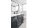 Stylish bathroom featuring a dark wood vanity, white countertop, modern fixtures, and a window at 140 88Th Ne Ave, St Petersburg, FL 33702