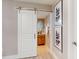 Bathroom featuring a modern barn door, vanity with storage, and stylish decor at 140 88Th Ne Ave, St Petersburg, FL 33702