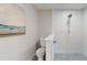 White tiled bathroom with rainfall shower and artwork at 140 88Th Ne Ave, St Petersburg, FL 33702