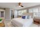 Bedroom featuring a sliding door to a walk in shower and shuttered windows at 140 88Th Ne Ave, St Petersburg, FL 33702