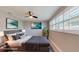Bedroom design with gray bedspread and headboard, accented by tropical artwork at 140 88Th Ne Ave, St Petersburg, FL 33702