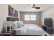 Well-furnished bedroom with bed, side tables, TV and decorative wall art at 140 88Th Ne Ave, St Petersburg, FL 33702