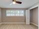 Cozy bedroom featuring modern ceiling fan, large window, and ample closet space at 140 88Th Ne Ave, St Petersburg, FL 33702