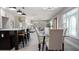 Open-concept kitchen and dining area with modern lighting, comfortable seating, and stylish doorway at 140 88Th Ne Ave, St Petersburg, FL 33702