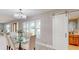 Dining area featuring a glass table, comfortable seating, and a modern sliding barn door at 140 88Th Ne Ave, St Petersburg, FL 33702