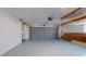 Spacious garage with epoxy flooring, storage cabinets, and a modern garage door at 140 88Th Ne Ave, St Petersburg, FL 33702