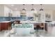 Modern kitchen featuring stainless steel appliances, a large island, and a dining area with comfortable seating at 140 88Th Ne Ave, St Petersburg, FL 33702