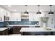 Bright kitchen featuring white cabinets, stainless steel appliances, and a spacious island at 140 88Th Ne Ave, St Petersburg, FL 33702