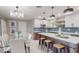 Bright open kitchen featuring stainless steel appliances, a large island, and an adjacent dining area at 140 88Th Ne Ave, St Petersburg, FL 33702