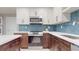 Modern kitchen showcasing stainless steel appliances, sleek white cabinets, and a stylish backsplash at 140 88Th Ne Ave, St Petersburg, FL 33702