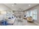Cozy living room with modern decor, a large window, and comfortable seating at 140 88Th Ne Ave, St Petersburg, FL 33702