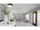 Open-concept living room featuring modern decor, ample seating, natural light, and stylish doorway at 140 88Th Ne Ave, St Petersburg, FL 33702