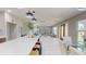 View of the open floorplan with an island, living room, dining area, and a front door at 140 88Th Ne Ave, St Petersburg, FL 33702