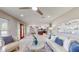 Bright living room featuring a ceiling fan, an open floorplan, and neutral colors at 140 88Th Ne Ave, St Petersburg, FL 33702