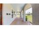 Covered porch with brick columns and a decorative glass front door at 140 88Th Ne Ave, St Petersburg, FL 33702