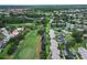 Expansive aerial view of the golf course community, highlighting lush greenery and tranquil water features at 140 Dale Pl, Oldsmar, FL 34677