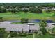 Scenic aerial view of community homes overlooking lush golf course and serene pond at 140 Dale Pl, Oldsmar, FL 34677